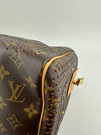 Close-up of a brown leather handbag with gold accents on a light gray background