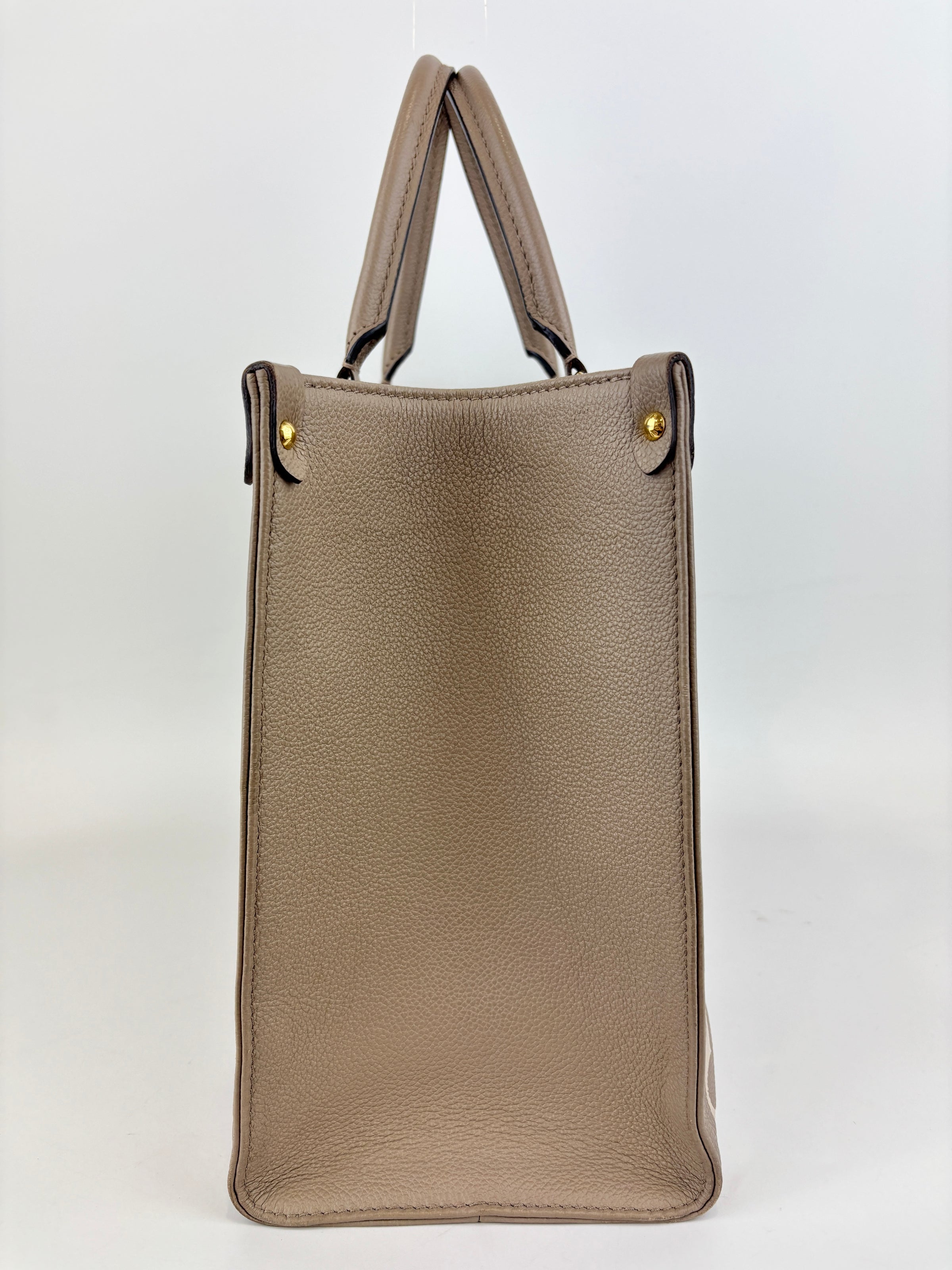 Onthego MM Bicolour Monogram Empreinte Leather Tourterelle / Crème