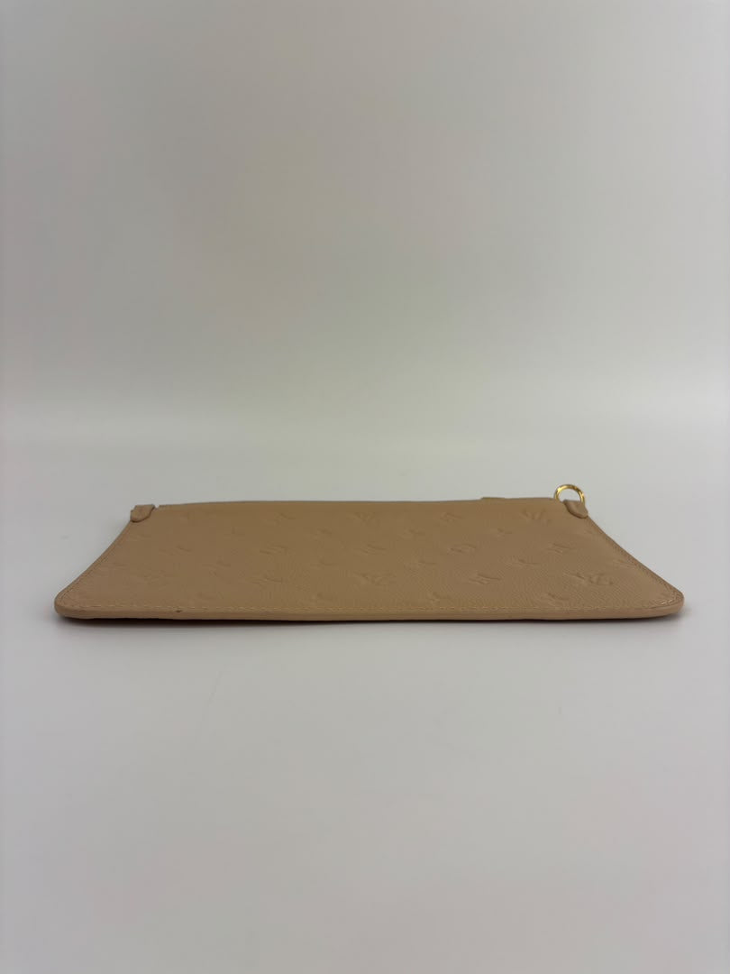 Neverfull Pouch in Monogram Empreinte Leather Crème