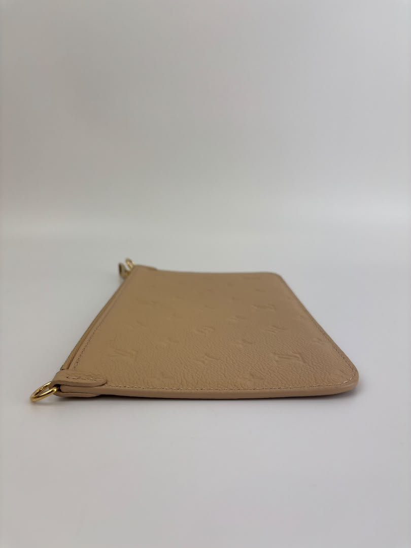 Neverfull Pouch in Monogram Empreinte Leather Crème