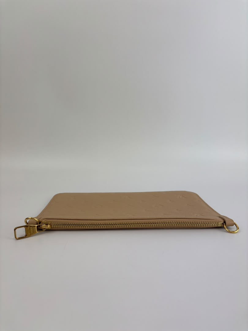 Neverfull Pouch in Monogram Empreinte Leather Crème