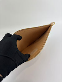 Neverfull Pouch in Monogram Empreinte Leather Crème