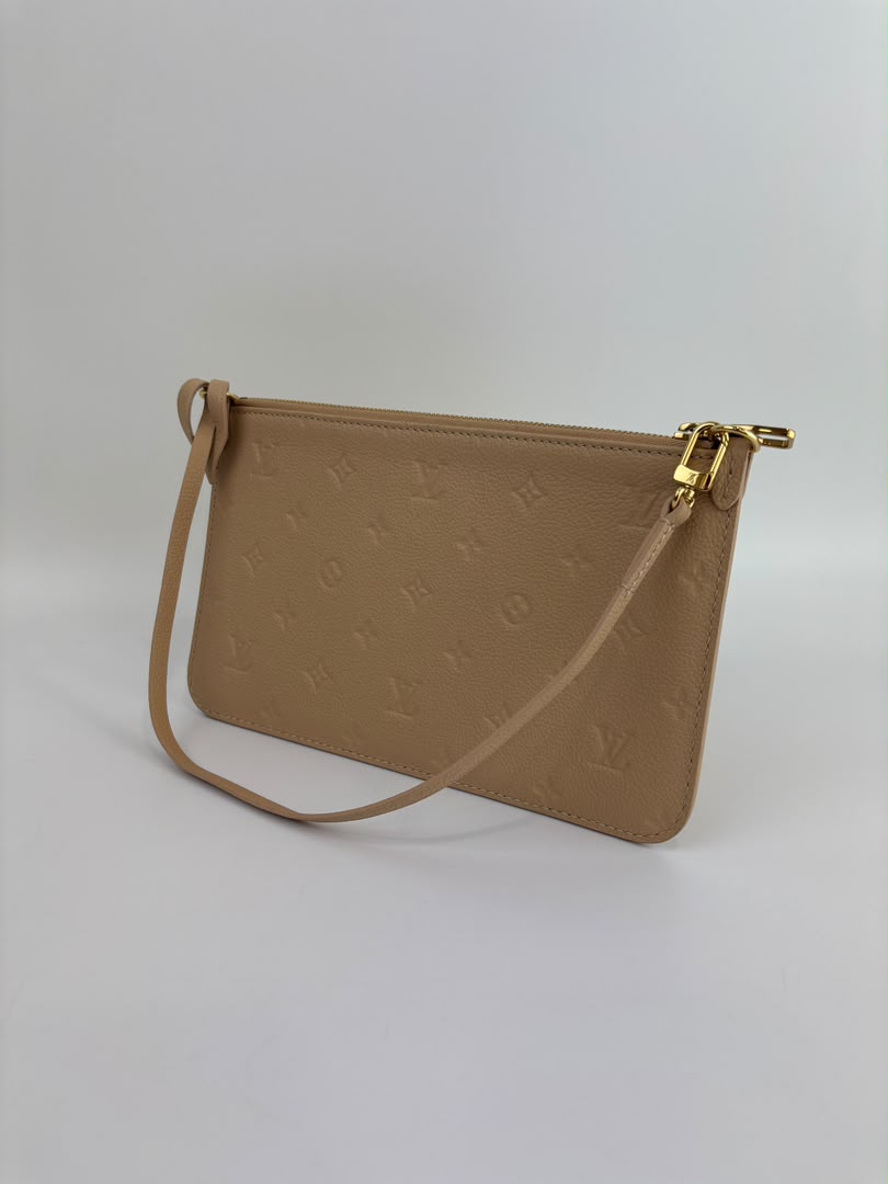 Neverfull Pouch in Monogram Empreinte Leather Crème