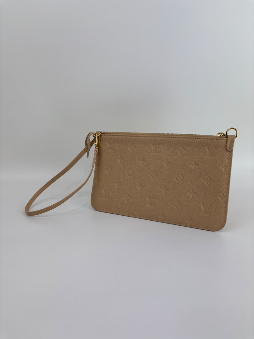 Neverfull Pouch in Monogram Empreinte Leather Crème