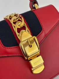 Gucci Sylvie Mini Leather Top Handle Crossbody Bag in Hibiscus Red - Glampot