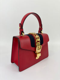 Gucci Sylvie Mini Leather Top Handle Crossbody Bag in Hibiscus Red - Glampot