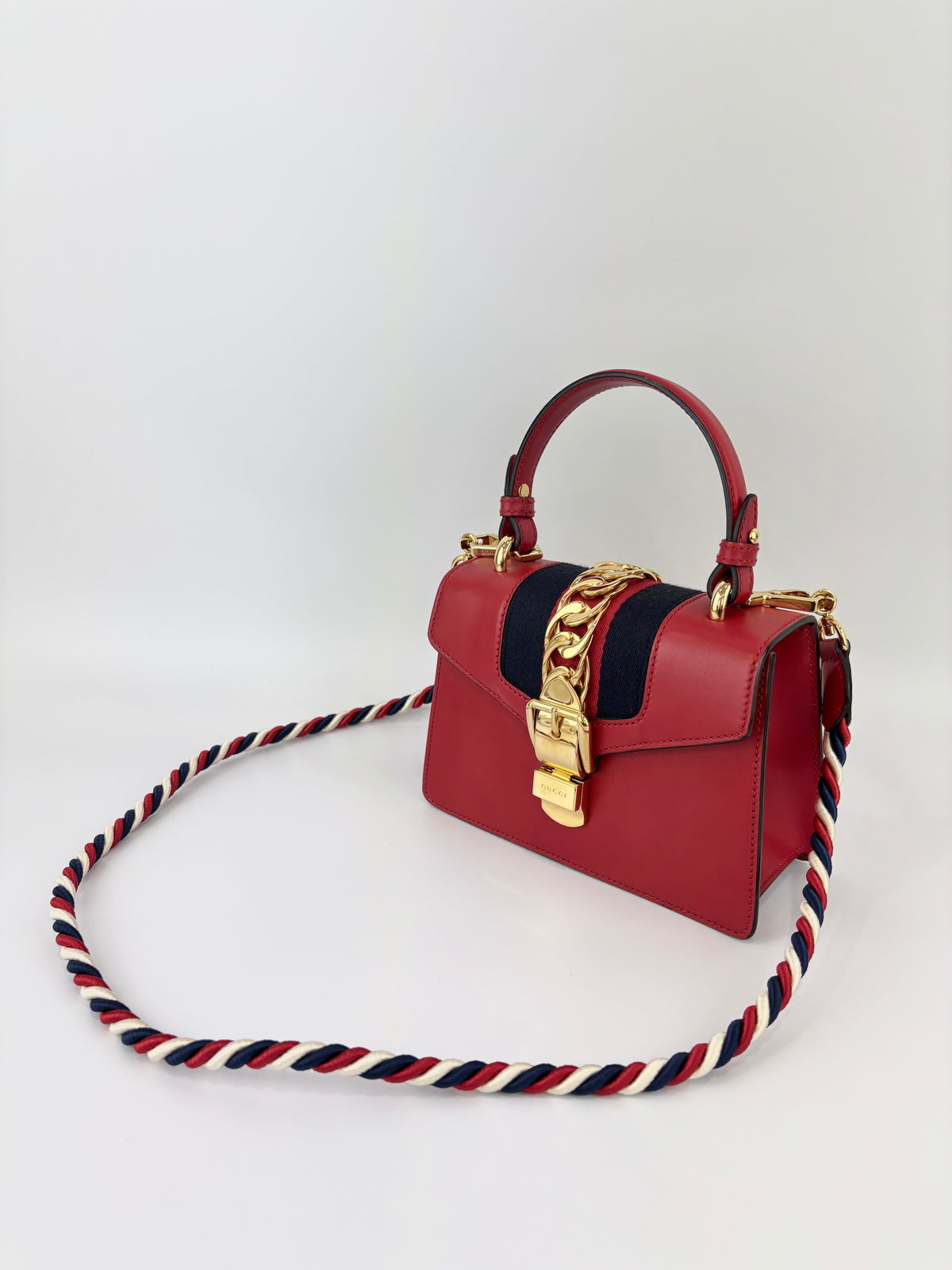 Gucci Sylvie Mini Leather Top Handle Crossbody Bag in Hibiscus Red - Glampot