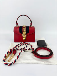 Gucci Sylvie Mini Leather Top Handle Crossbody Bag in Hibiscus Red - Glampot