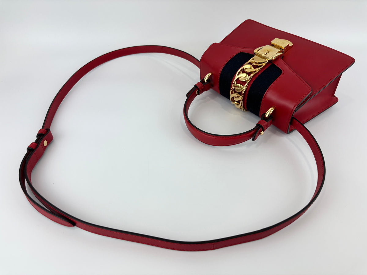 Gucci Sylvie Mini Leather Top Handle Crossbody Bag in Hibiscus Red - Glampot