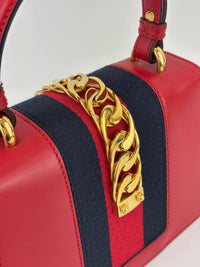 Gucci Sylvie Mini Leather Top Handle Crossbody Bag in Hibiscus Red - Glampot